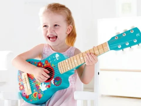 a child holding a guitar