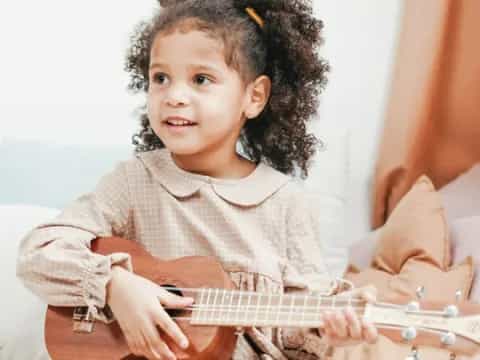 a child playing a guitar