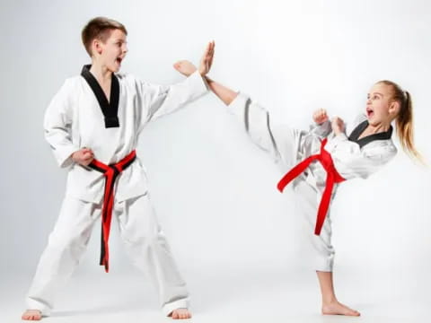 a man and a woman in karate uniforms