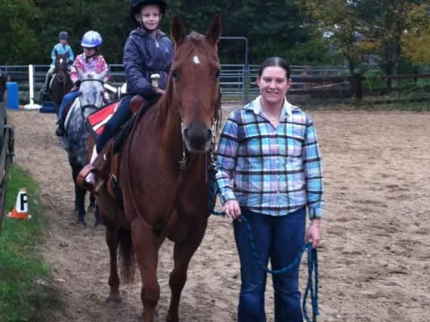 a man and a woman with a child on a horse