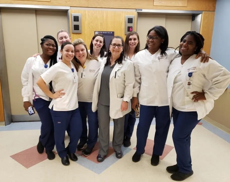 a group of women in white lab coats