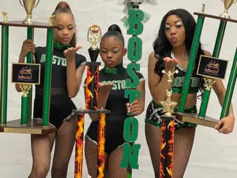 a group of women holding trophies