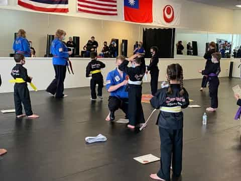 a group of people in a room with flags