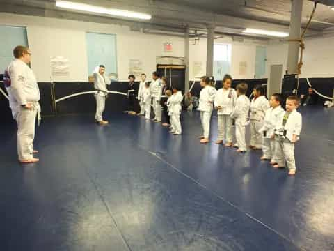 a group of people in white karate uniforms