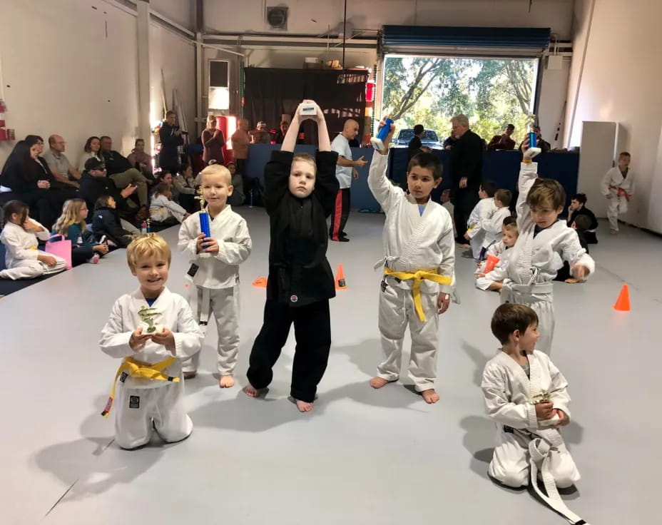 a group of children in karate uniforms