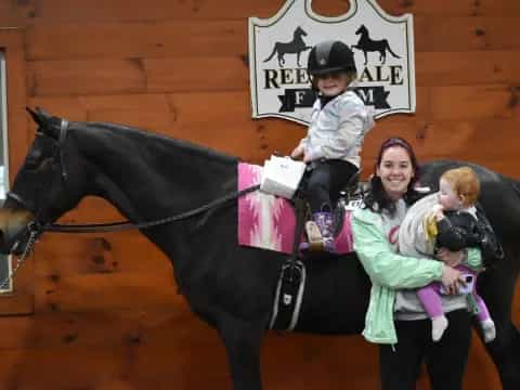 a person and two children on a horse