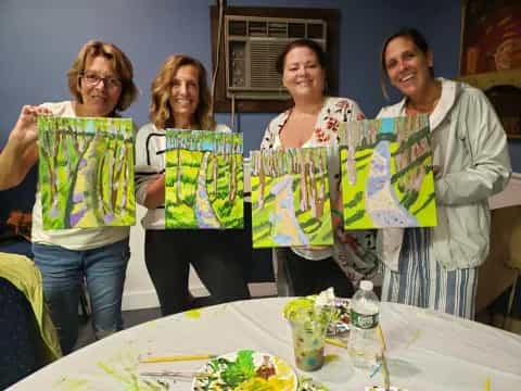 a group of women standing next to a table with food