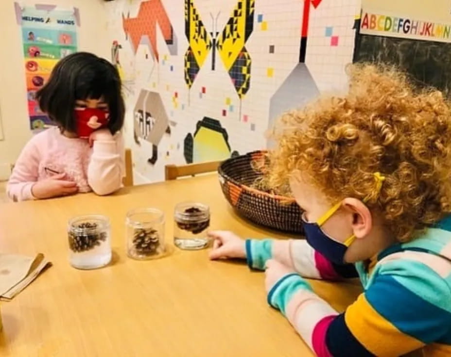 a young girl and a young girl painting on a table