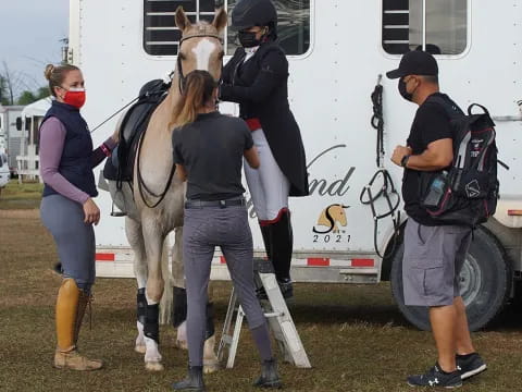 a group of people with a horse