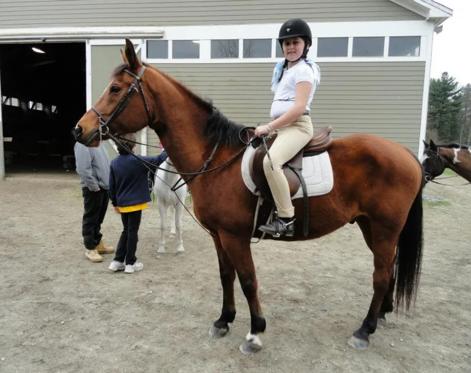 a girl riding a horse