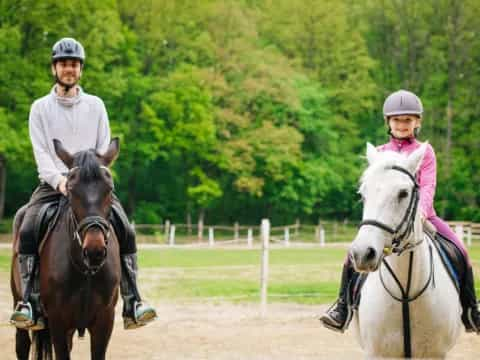 a group of people ride horses