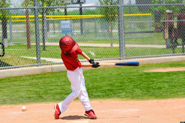 a kid swinging a baseball bat