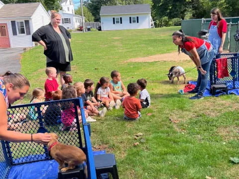 a group of children and a person playing in a yard