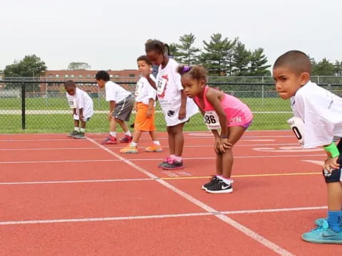 a group of children running on a track