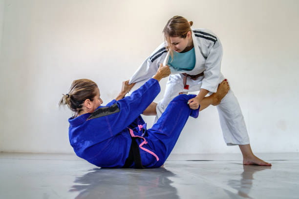 a woman and a man doing martial arts