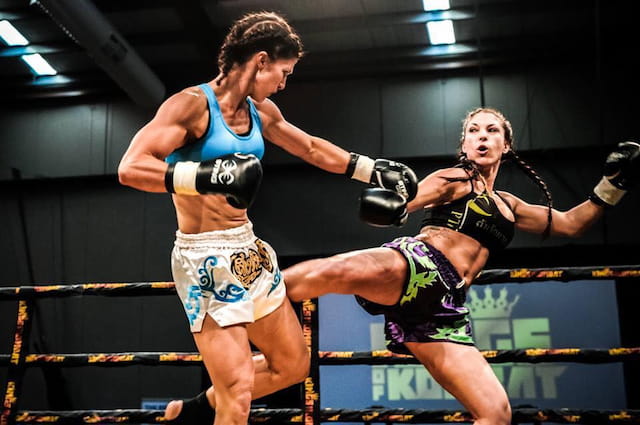 a man and a woman fighting in a boxing ring