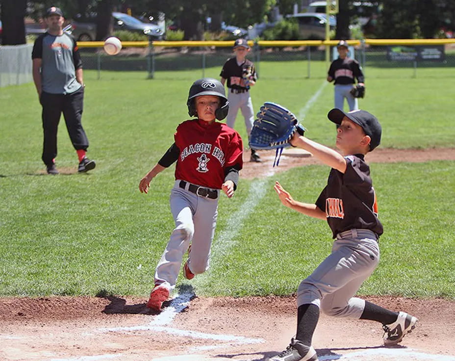 kids playing baseball on a field