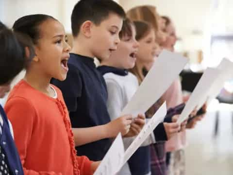 a group of students looking at a paper