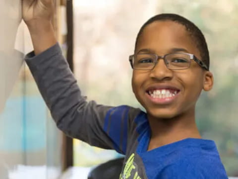 a boy holding a pen