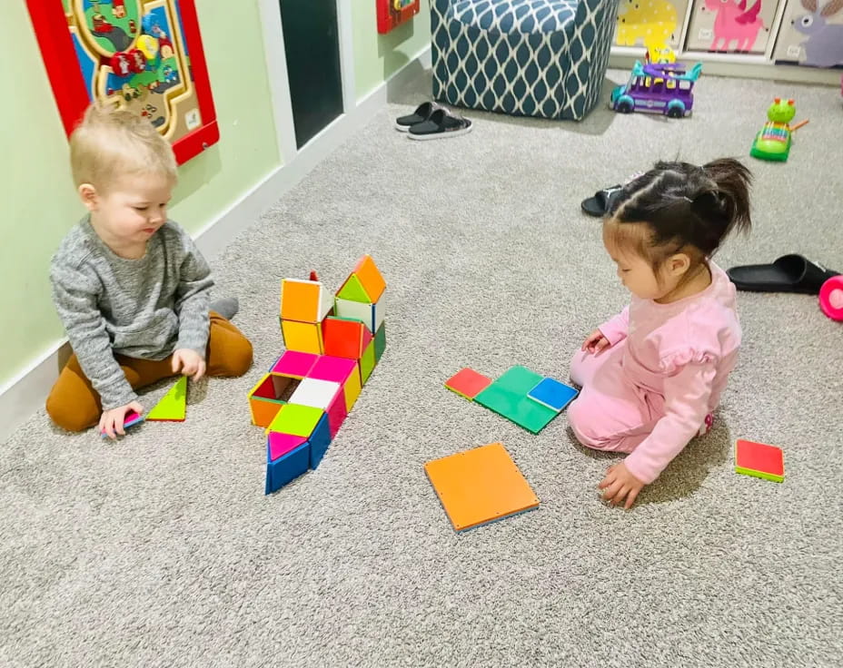a couple of children playing with toys