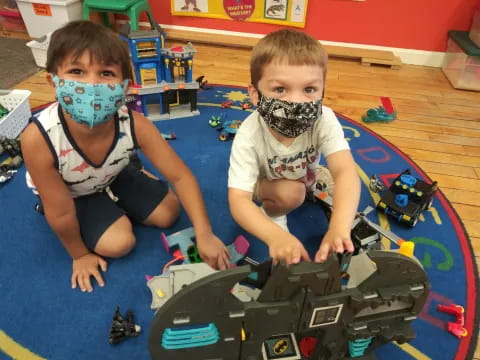 two boys playing with toys