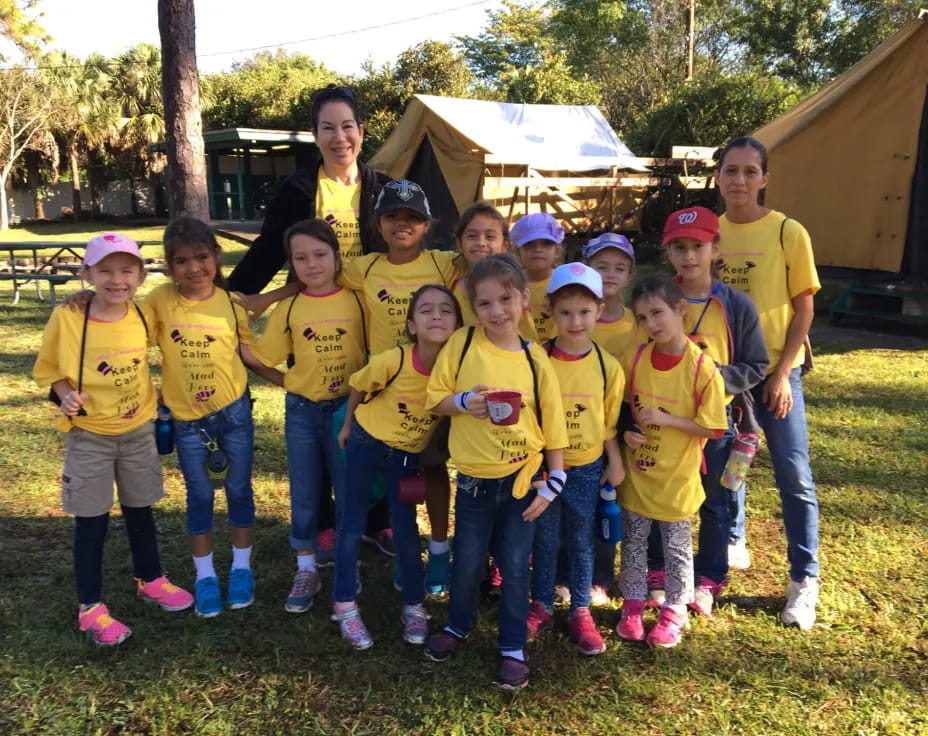 a group of children in matching yellow t-shirts