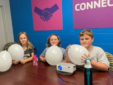 a group of people holding balloons