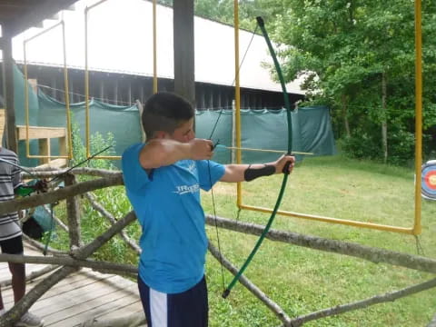 a boy holding a bow and arrow