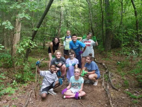 a group of people posing in the woods