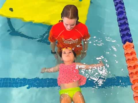 a person and a child in a pool