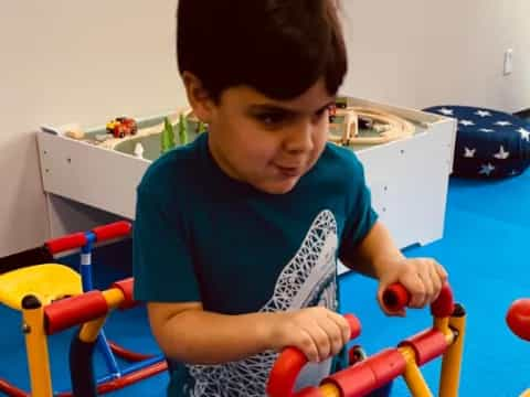 a boy holding a toy