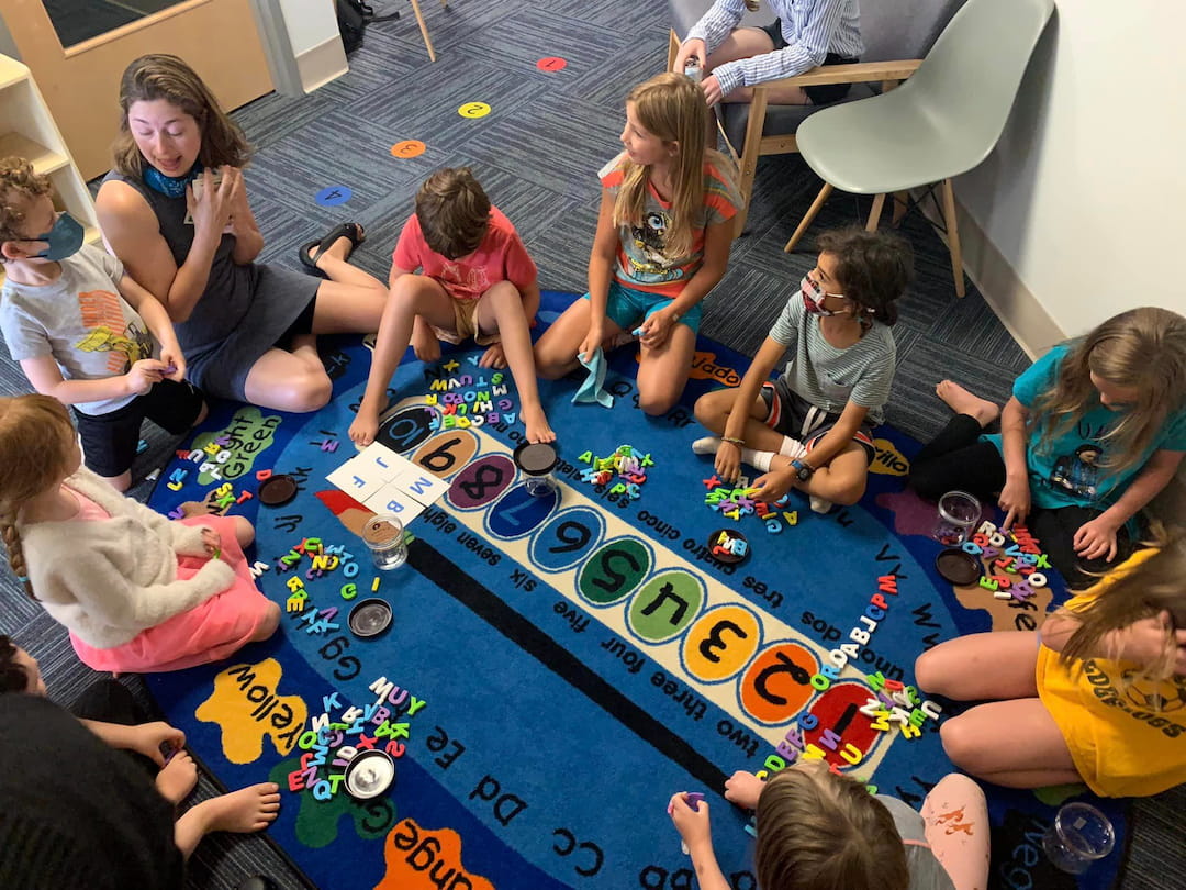 a group of people sitting around a table playing a board game