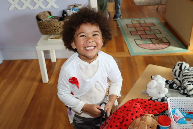 a child smiling at the camera