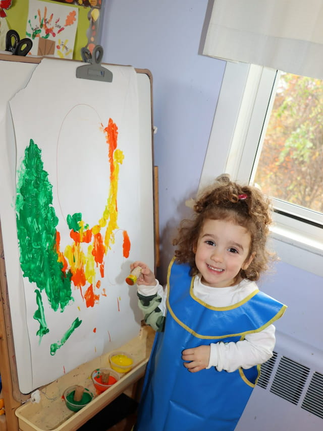 a girl holding a toy