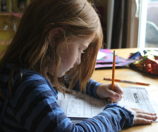 a person writing on a piece of paper