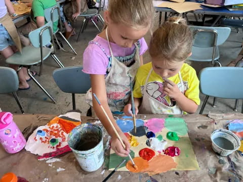 a couple of children painting