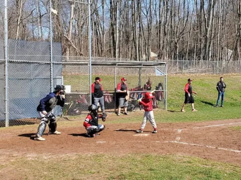 a group of people playing baseball