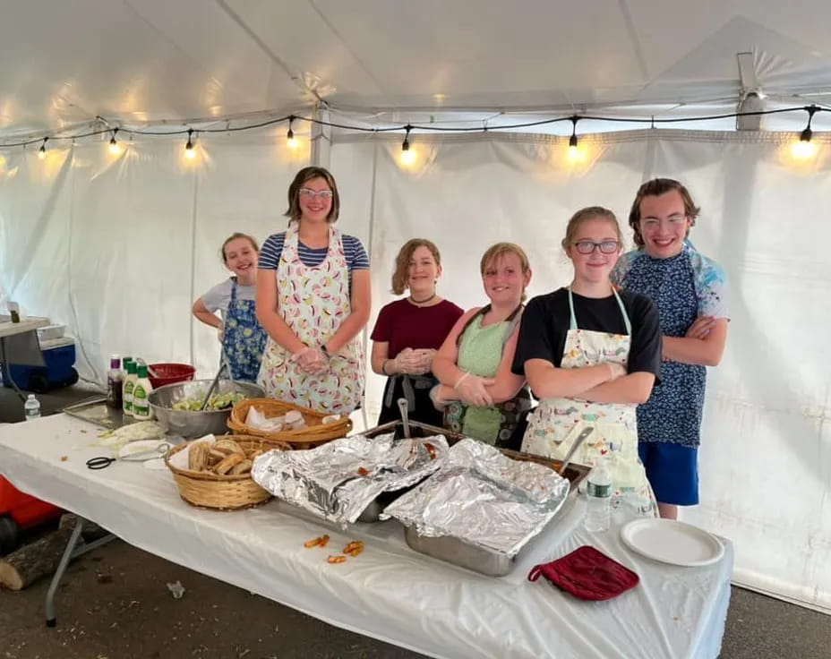 a group of women standing in a tent