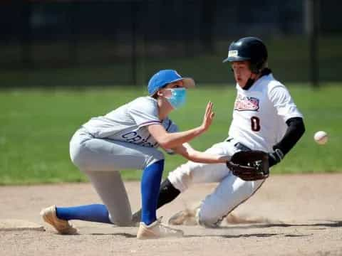 a couple of women playing baseball