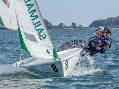 a couple of men sailing on a boat