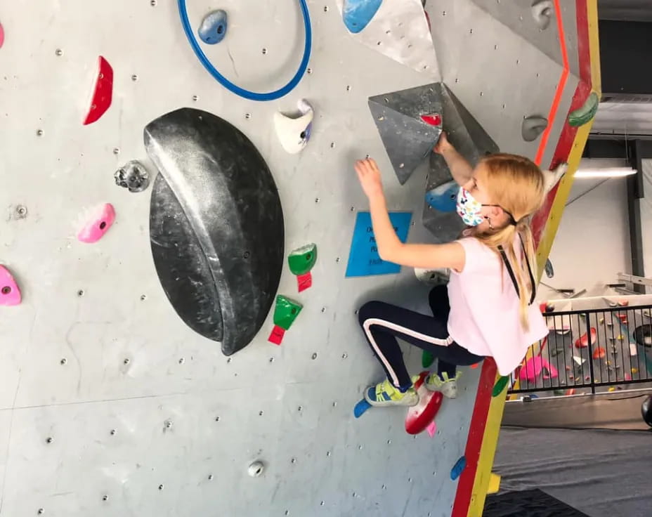 a girl climbing a wall