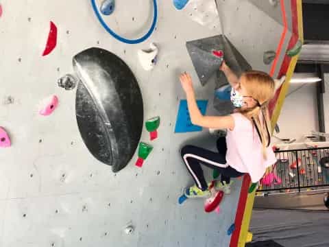 a girl climbing a wall