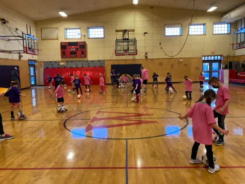 a group of people playing basketball