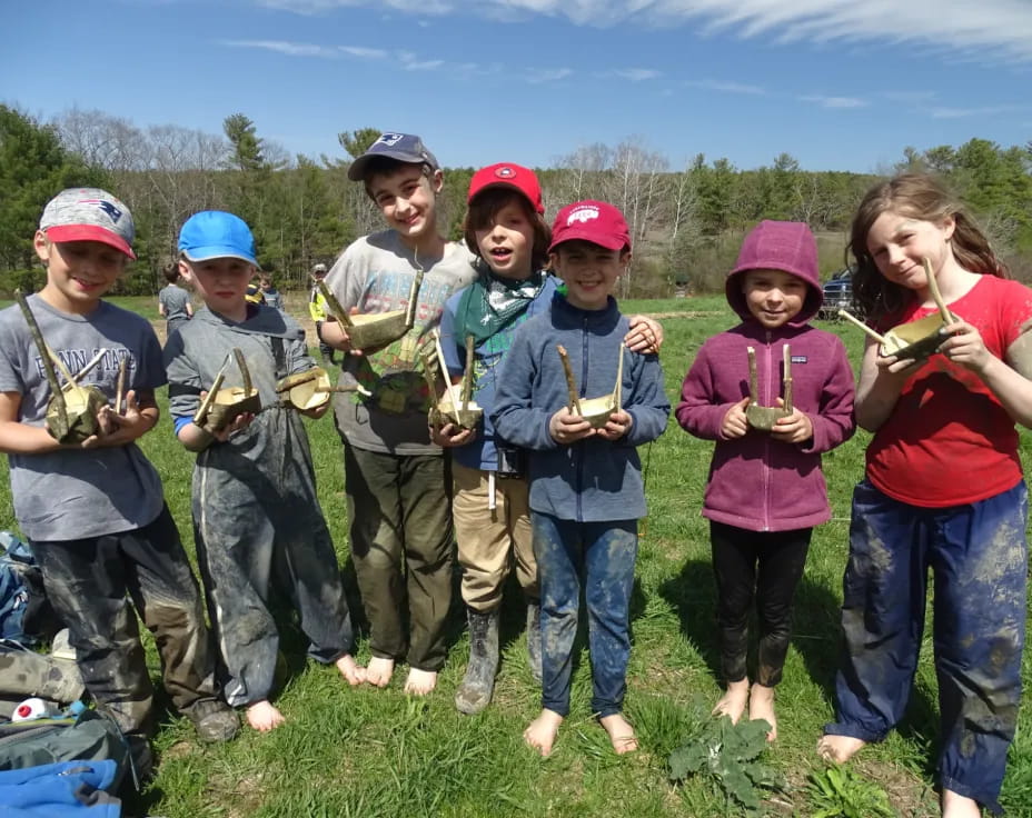 a group of kids holding fish