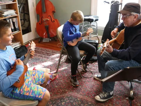 a person and a boy playing the guitar