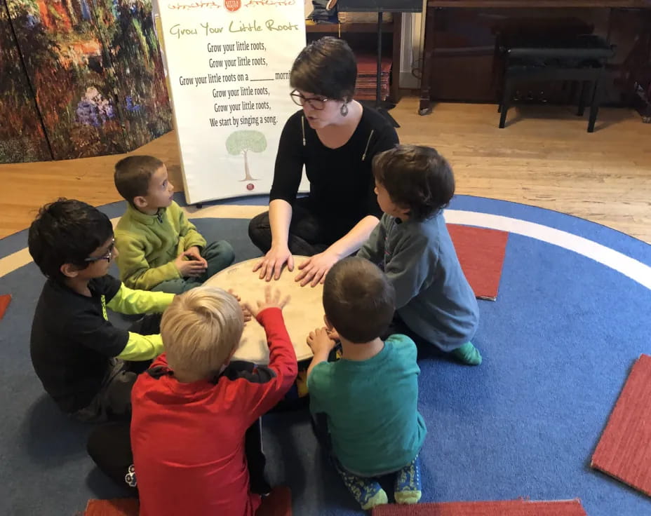 a person and several children sitting on the floor