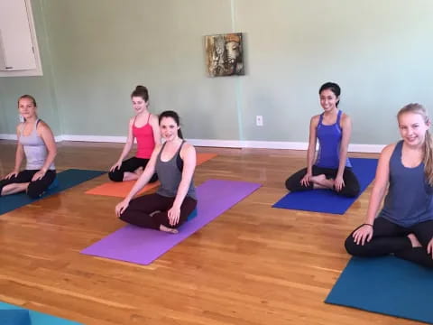 a group of women sitting on yoga mats