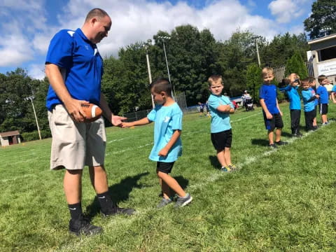 a group of kids playing football