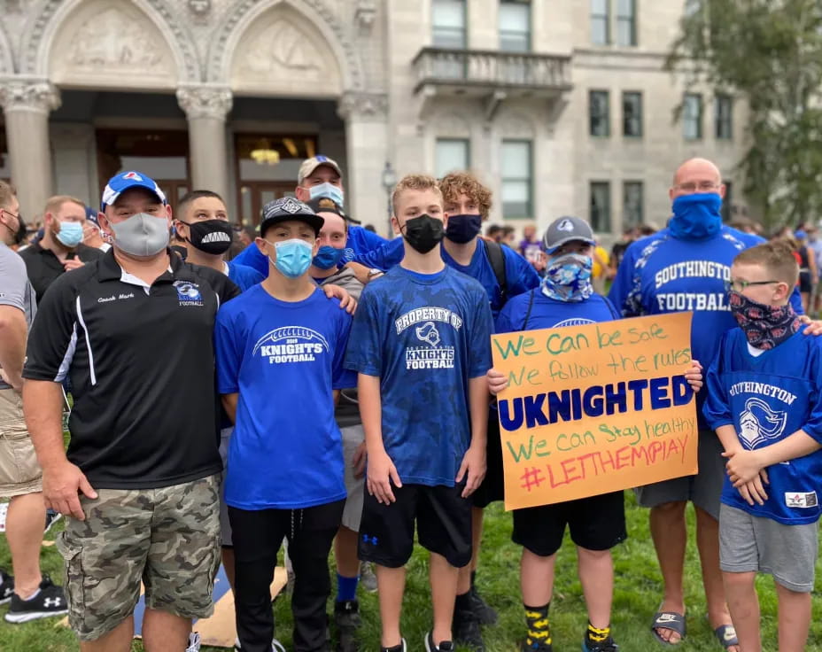 a group of people holding a sign