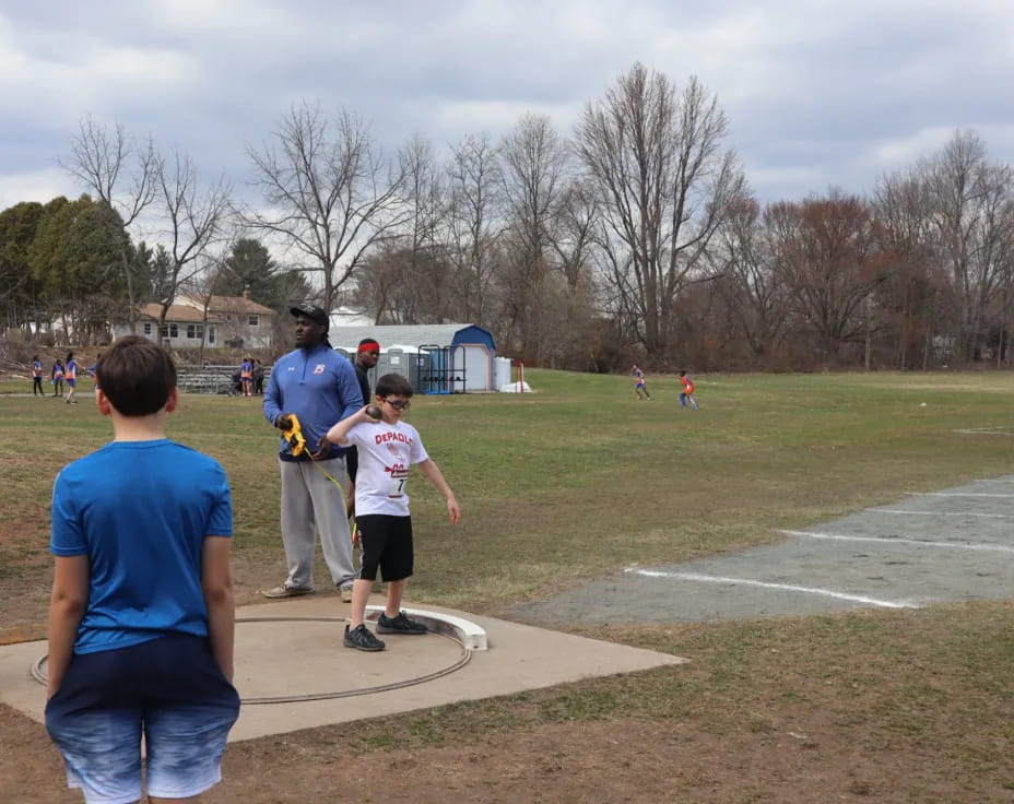 a group of people playing in a field